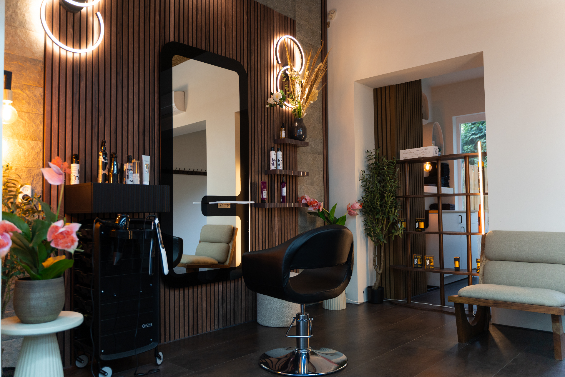 Styling station with mirror, products and salon chair at Icon Hair Salon Amsterdam Zuid